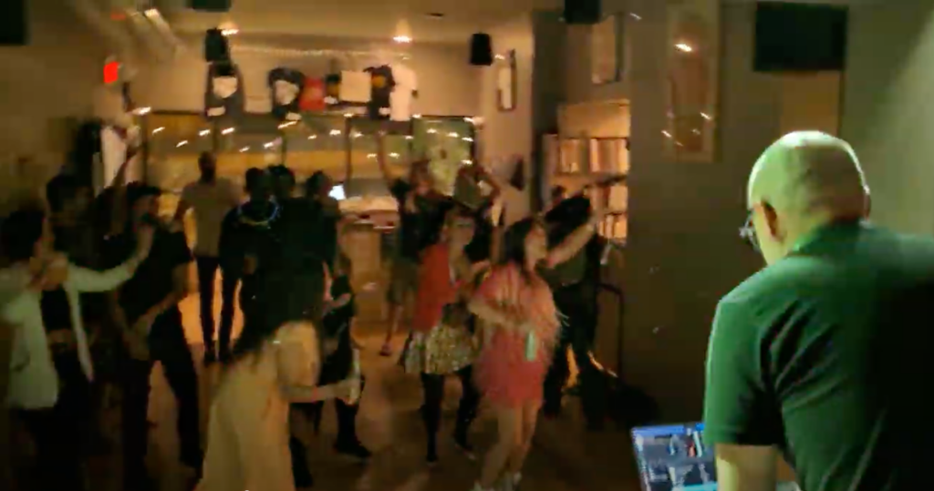 A crowd of people dancing at the Frostapalooza afterparty with DJ John Mullin